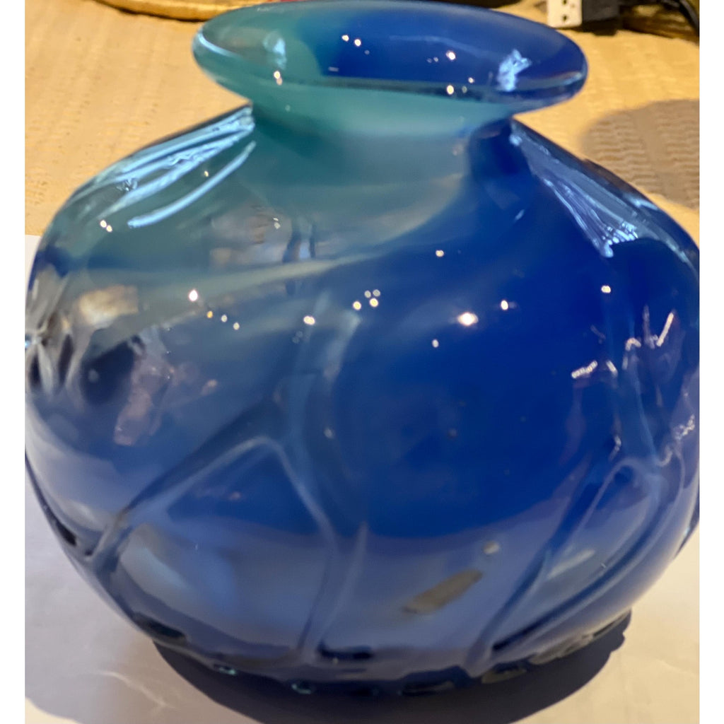Blue glass vase on a light-colored surface